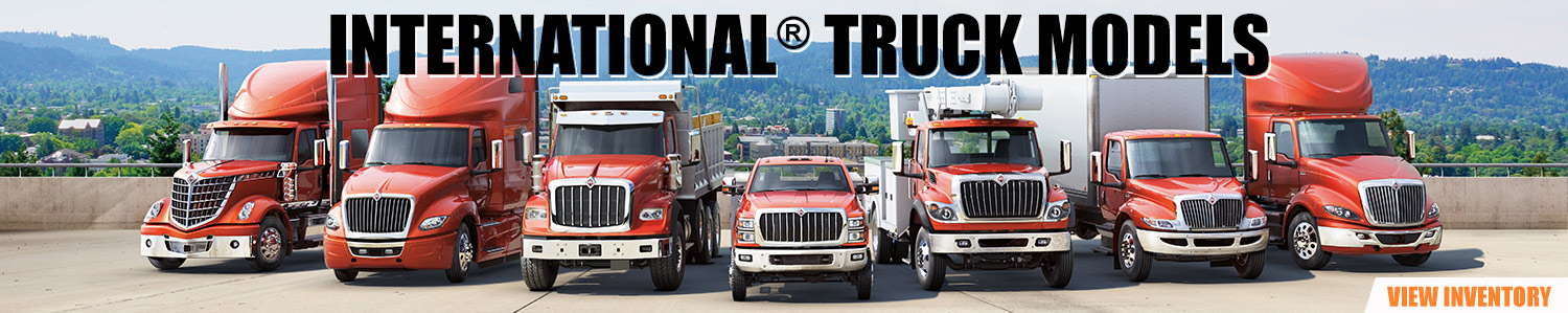 A lineup of every International® truck series that's displayed in a lot overlooking a town